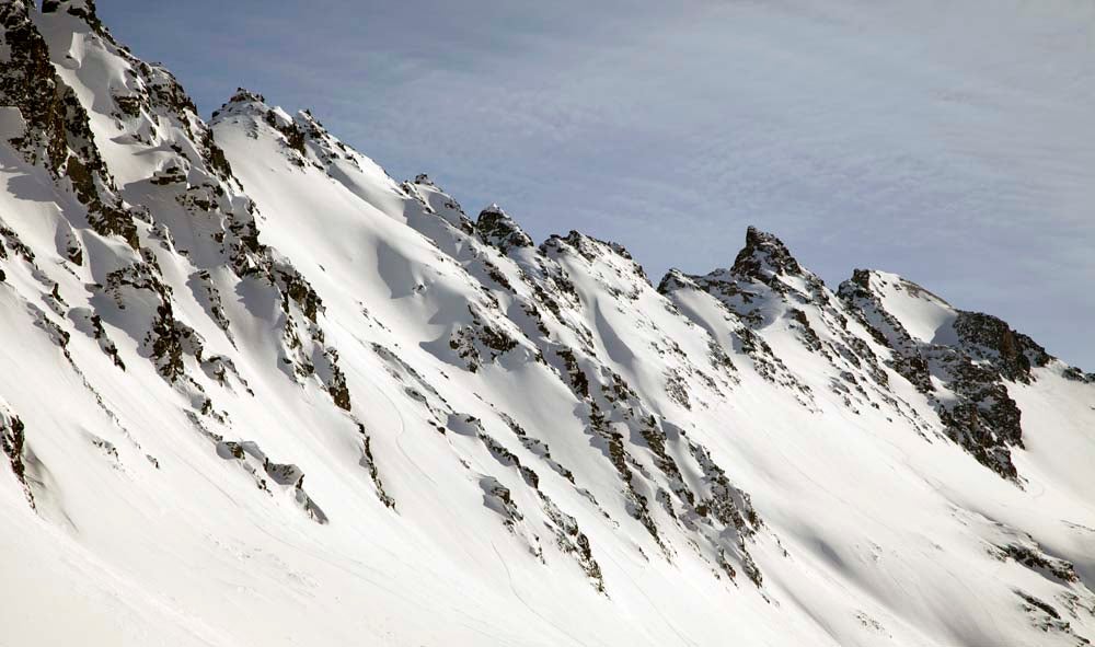 Valdez, AK This is a view of a region called the Iguana Backs. Valdez Heli-Ski Guides can you to this terrain, to ski 1,500-foot-long couloirs of creamy Chugach…