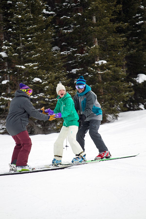 Playing the Game This overly qualified skiboarder has mastered the role of the damsel in distress and managed to wrangle two strapping young lads to