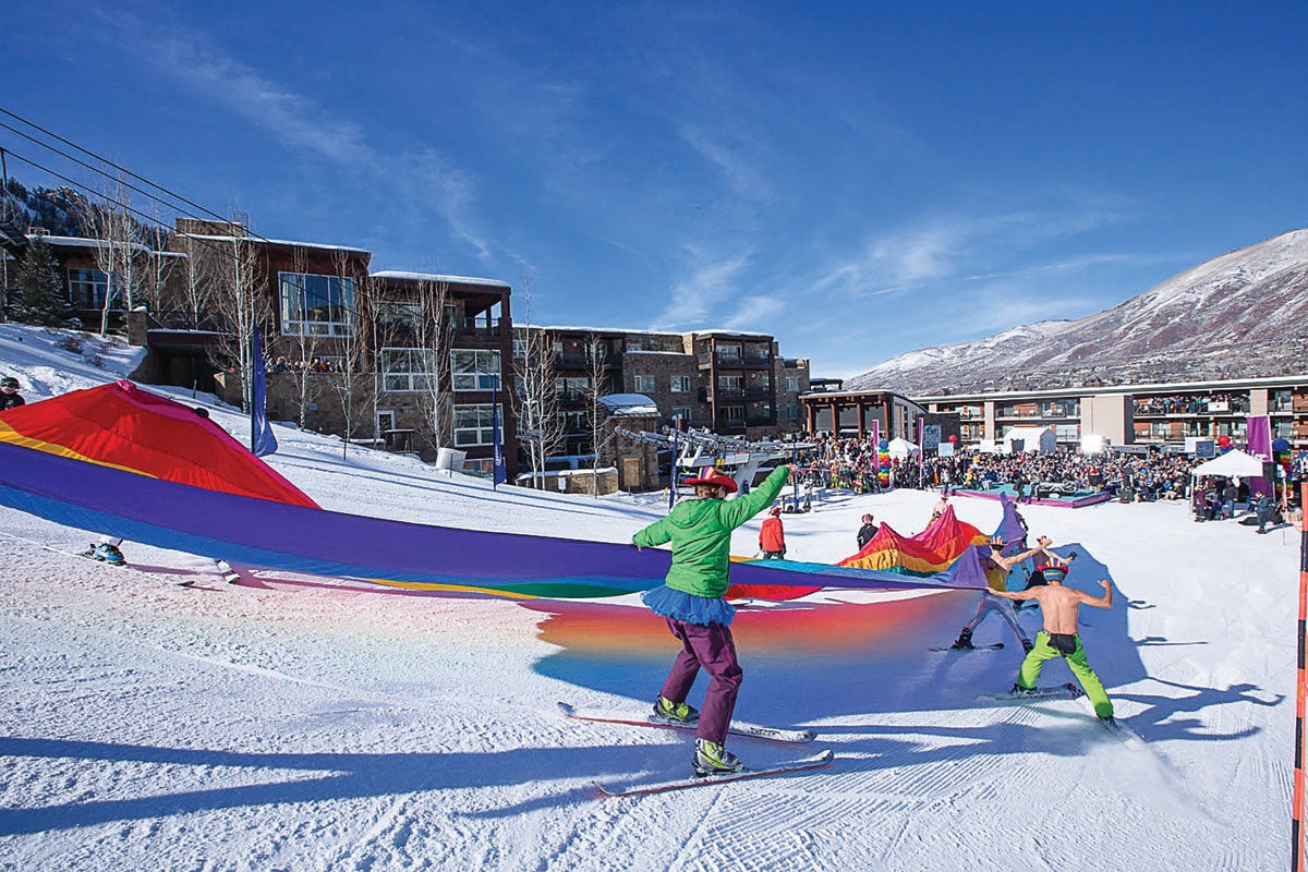 SKI1116_Aspen_Gay_Ski_Week15_1 Skiers with a rainbow flag at Aspen Mountain