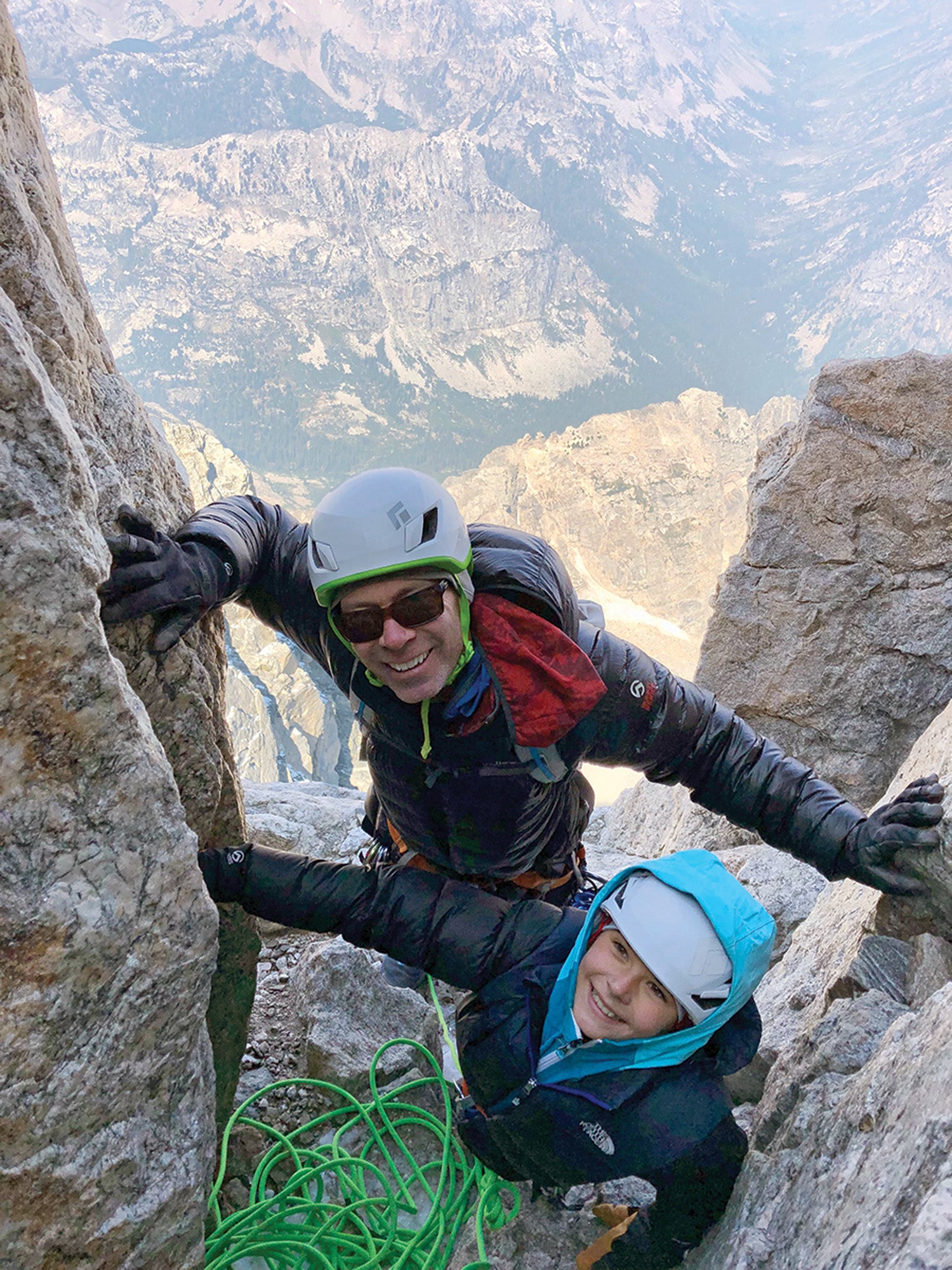 SNW70-Jackson5-coKitDeslauriers copy Rob Deslauriers and his daughter climbing up the side of a mountain with a distant canyon underneath them