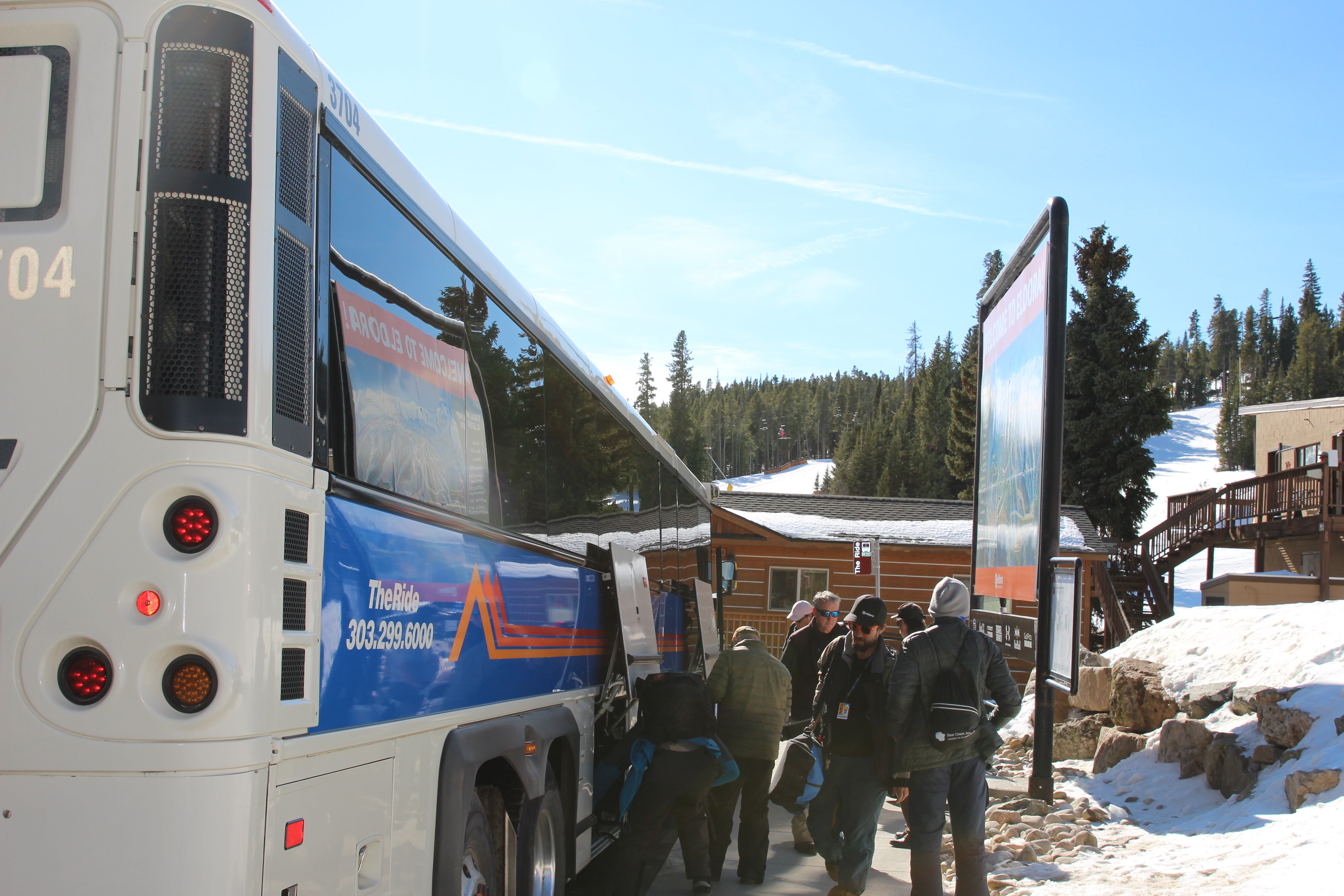 use 2 Skiers hopping off the bus at Eldora Mountain Resort.