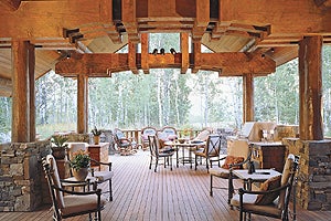 Mountain Life Thick logs running the length of the kitchen draw the eye to the windows and bring the 18-foot-high ceilings down to create a cozy feel.