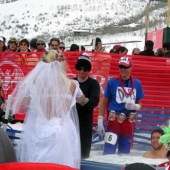 Beautiful Bride A man dressed up in a wedding dress gets ready to jump into the hot tub after falling in the water on his run. Looks like an amusing scene.