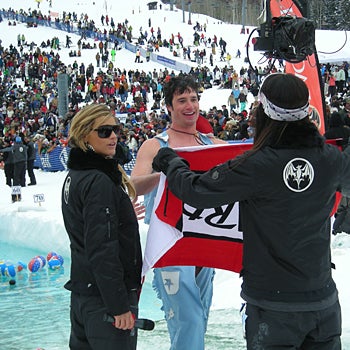Warm-Up A cowboy gladly accepts warm towels from a Bacardi girl. Competitors went straight from the icy water to hot tubs at the end of the course.