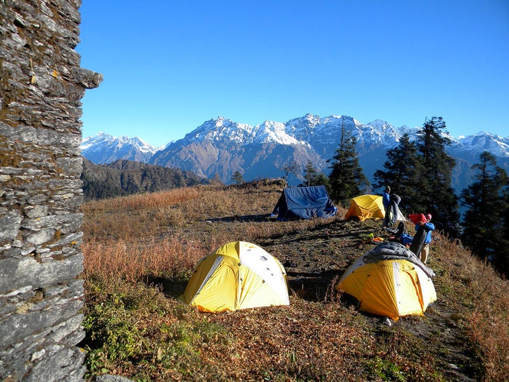 Closing Time Packing up camp on a chilly morning in transit as the Himalayan range fills the horizon.