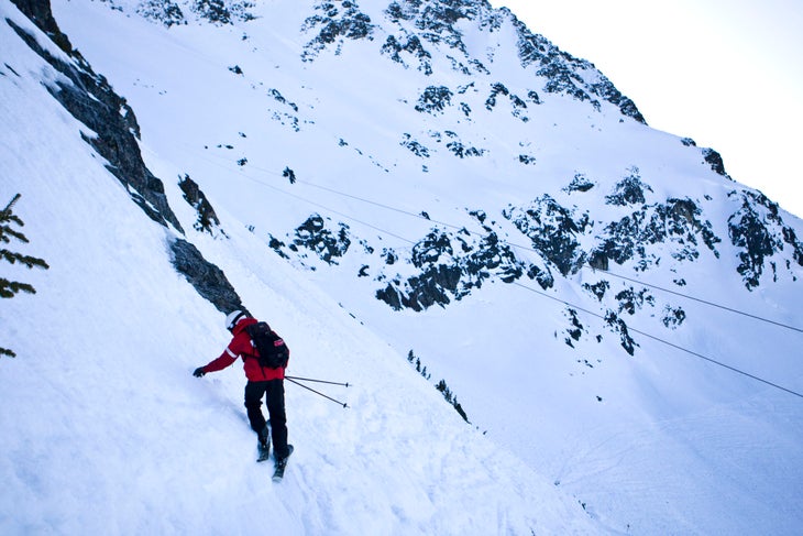 Nigel Stewart checks snow conditions on Blackcomb mountain during the Olympics Stewart checks the depth of the sun crust on an early morning patrol lap. With weather being unseasonably warm and sunny, (perfect for Olympic…