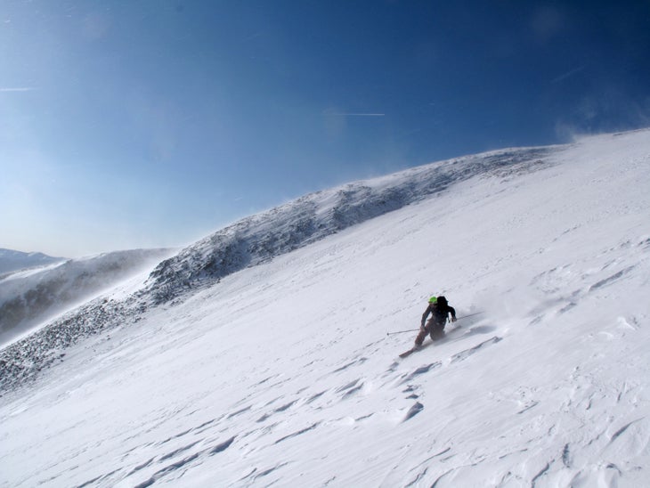 Shredding the Moonscape Kevin Luby drops a knee on the wind-scoured snow at the top of the couloir.