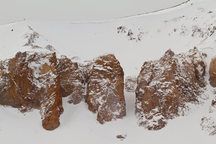 Discrete athlete Julian Carr, top left, waits to descend his line. None