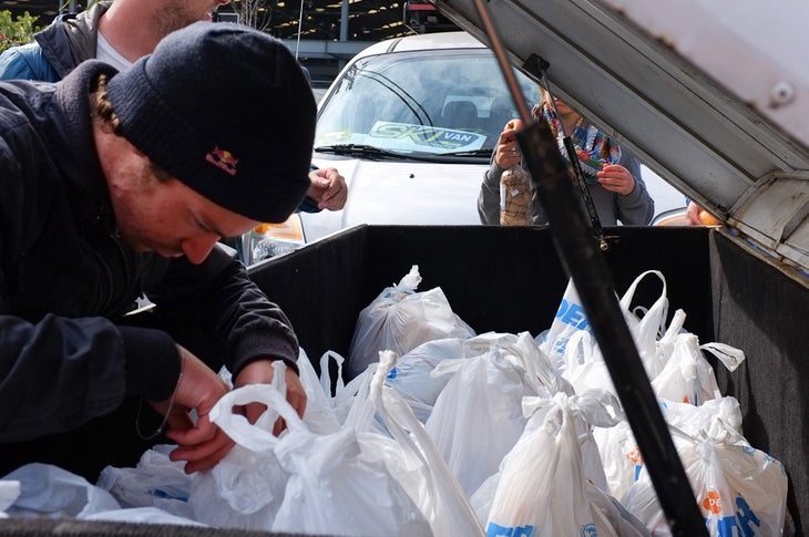 Sean Pettit, part of the K2 Factory Team, packs up groceries outside a supermarket in Santiago, Chile, before heading to La Parva None