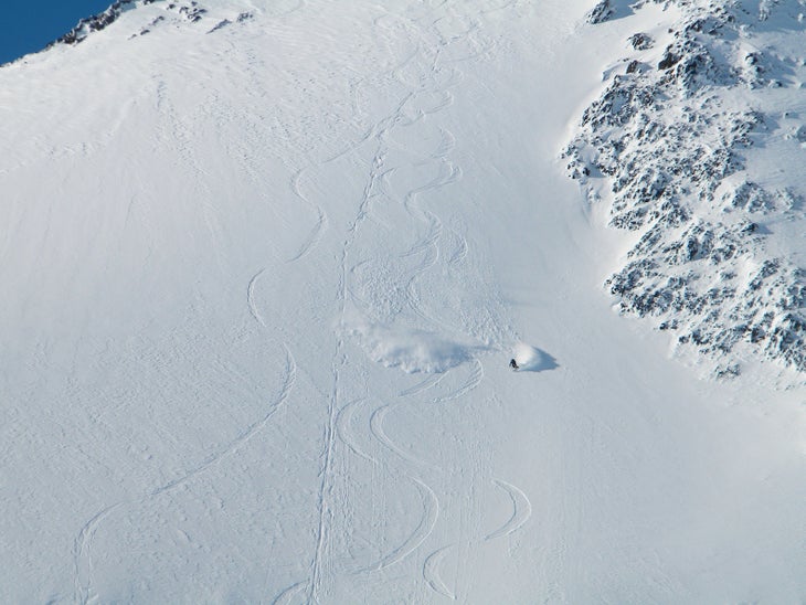 Acapulco Photographer Court Leve carves into a steep face called Acapulco while skiing with Alaska Backcountry Adventures, one of Valdez's most popular…