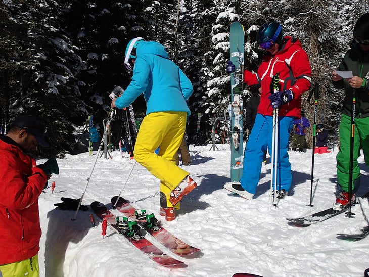 Ski Tester Being Adjusted Two ski techs kept the skiers moving after a quick binding adjustment for each ski.