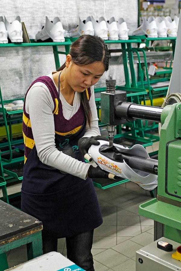 Handmade with Love A worker attaches the snow seal to a Maestrale RS. No fewer than 110 bootmakers steer each boot through the production process.
