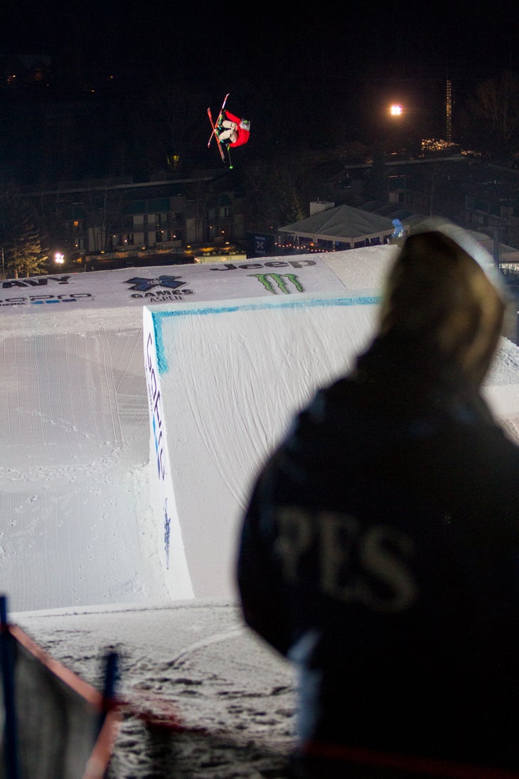 Alex Beaulieu-Marchand Alex Beaulieu-Marchand (CAN) throws a switch double cork safety grab on the GoPRo Big Air jump while X Games security personnel look on.