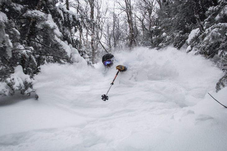 Jay Peak Skier Duane Wheeler’s tracks start where others stop. Here, he hammered through a fresh February line, choking on some flakes along the way.