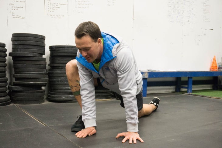 "Forrest Jillson performs instep-stretch, part of his ski fitness workout"