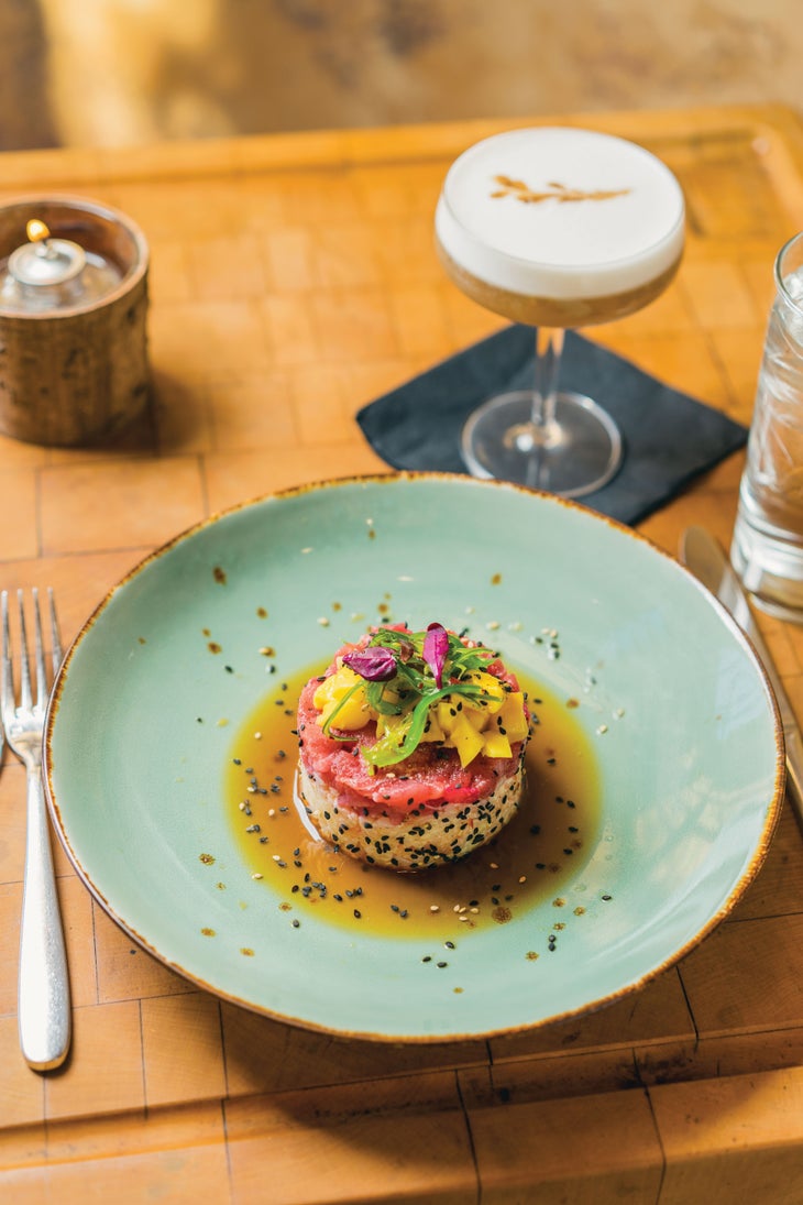 SKI0218_TRA4_creditCoreyKopischke The town features top-notch dining. Shown, Table 79 Food Bar's tuna poe with toasted sesame, burnt mango, fiery sticky rice, and charred scallion…