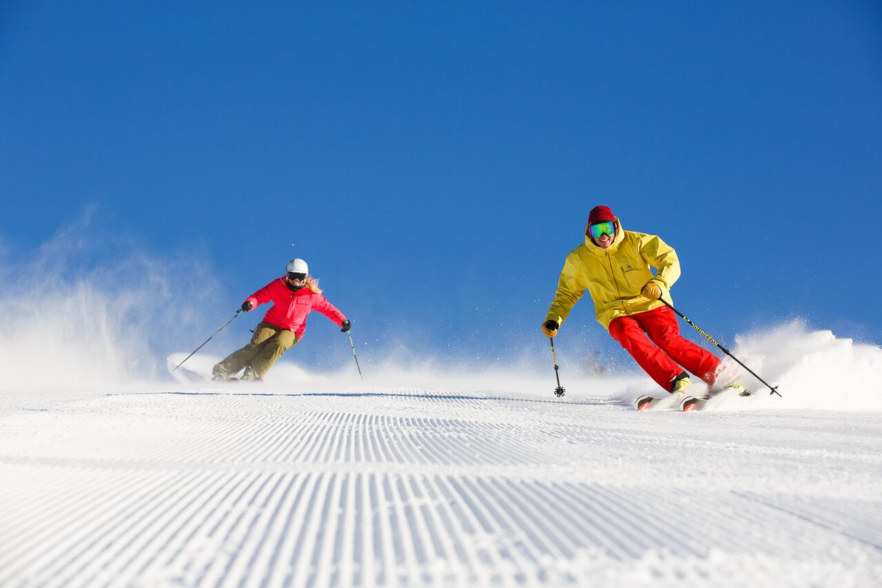 "Thredbo skiers enjoying groomed runs."