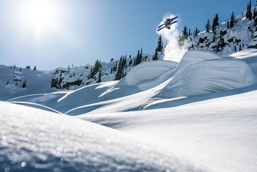 "Skier Sammy Carlson performing ski trick of jump in British Columbian Backcountry"