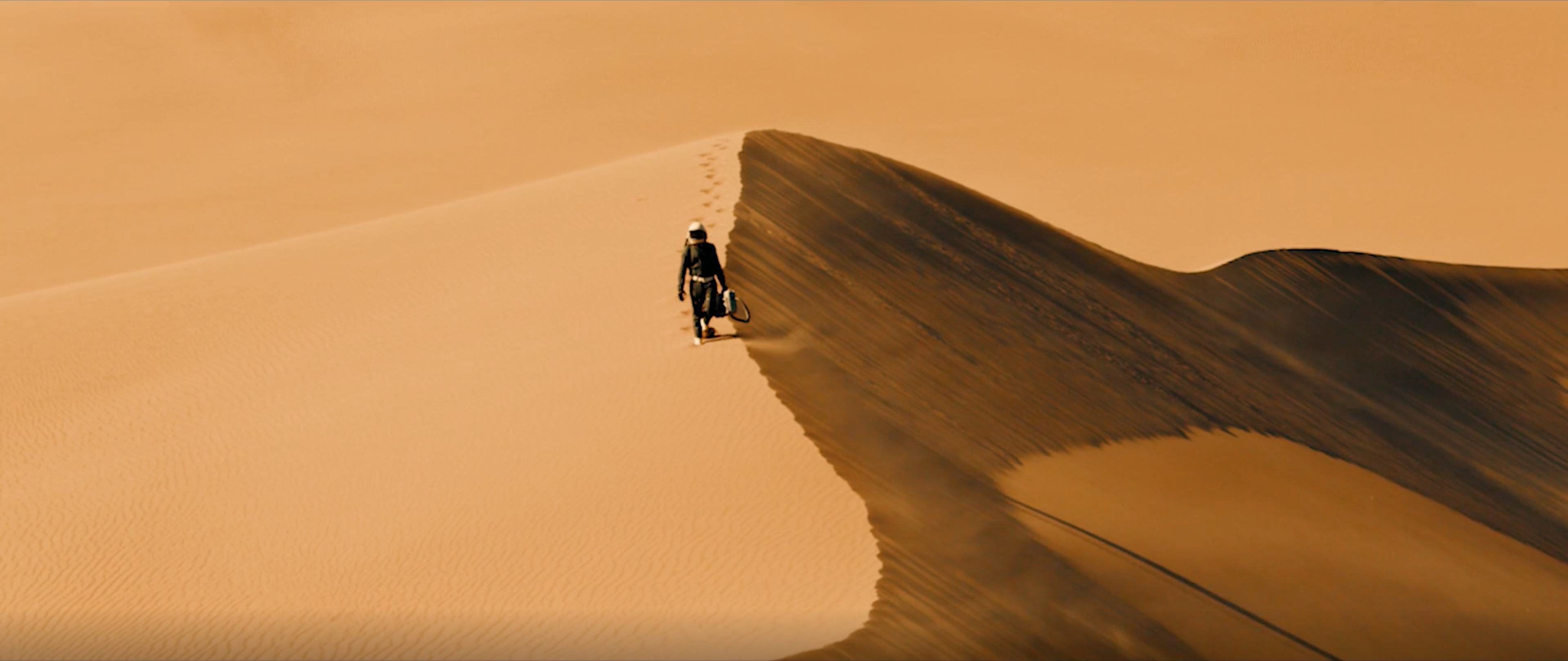 "Man walks on sand dunes in DPS' The Lonely Star."