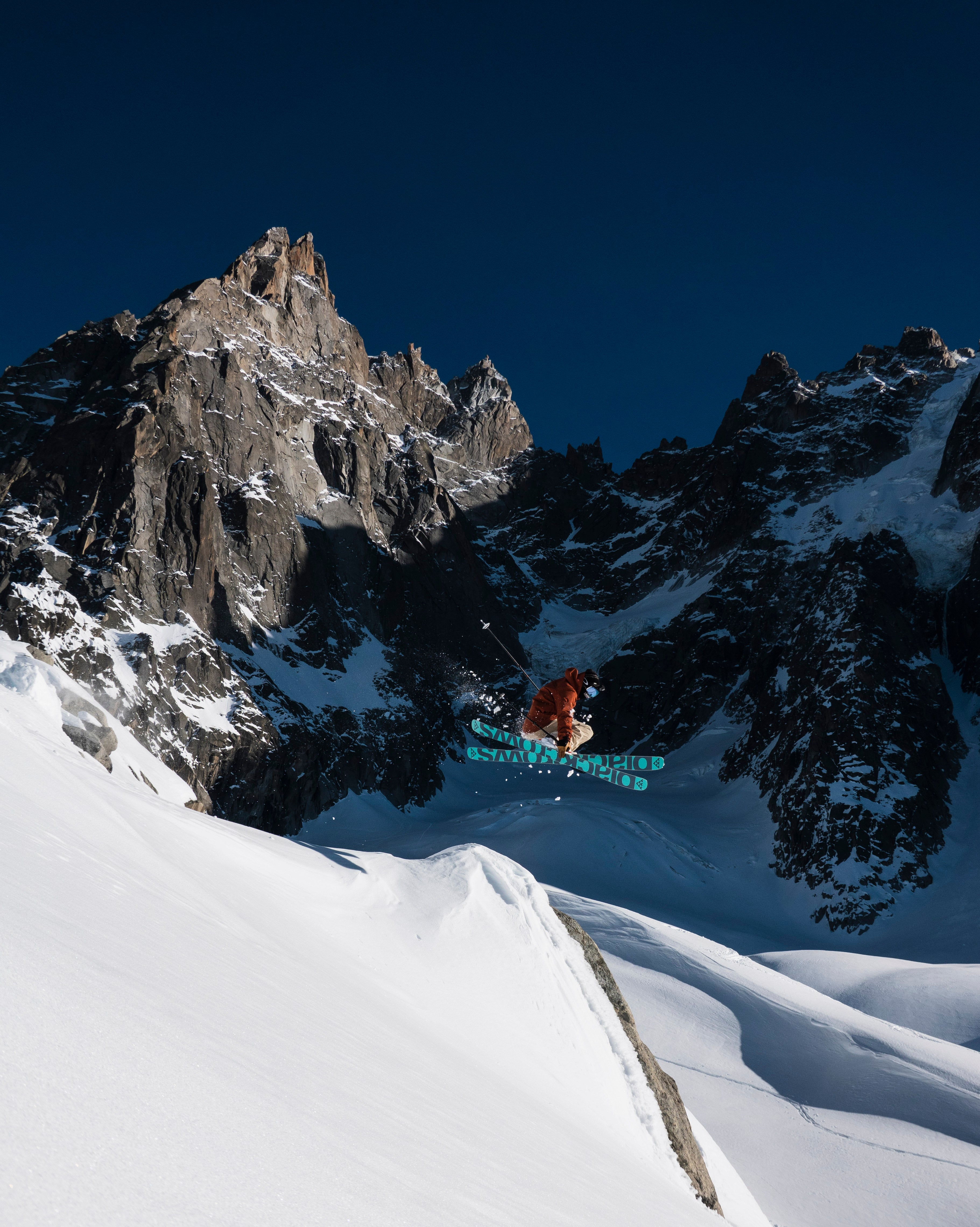 "Skier grabbing skis in air"