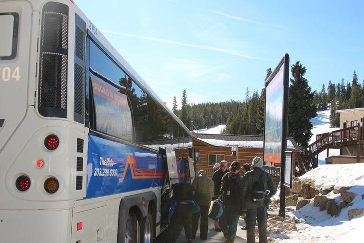 "Skiers hopping off the bus at Eldora Mountain Resort."