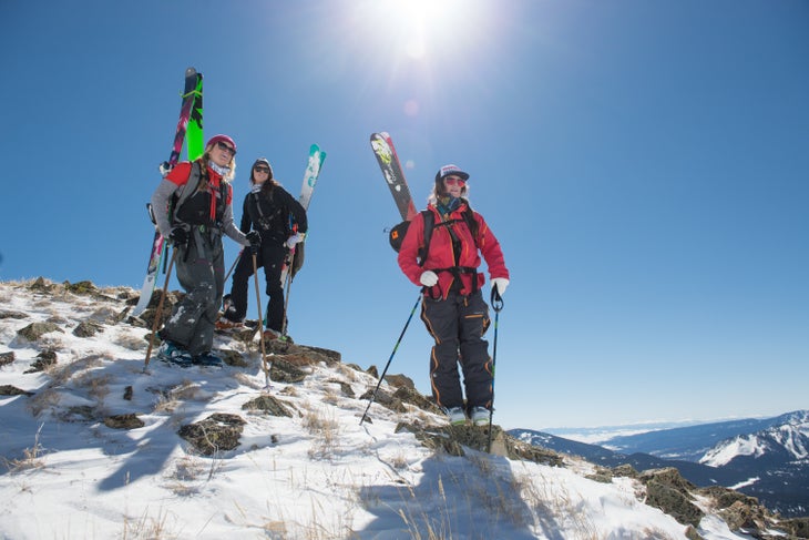 Eleven_Colorado-9790 Three skiers with their skis on their backs on a ridge near Crested Butte