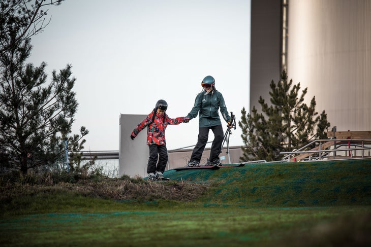 _O5A6227 A ski instructor helps a trainee side-step a small incline on Copenhill in Copenhagen, Denmark.
