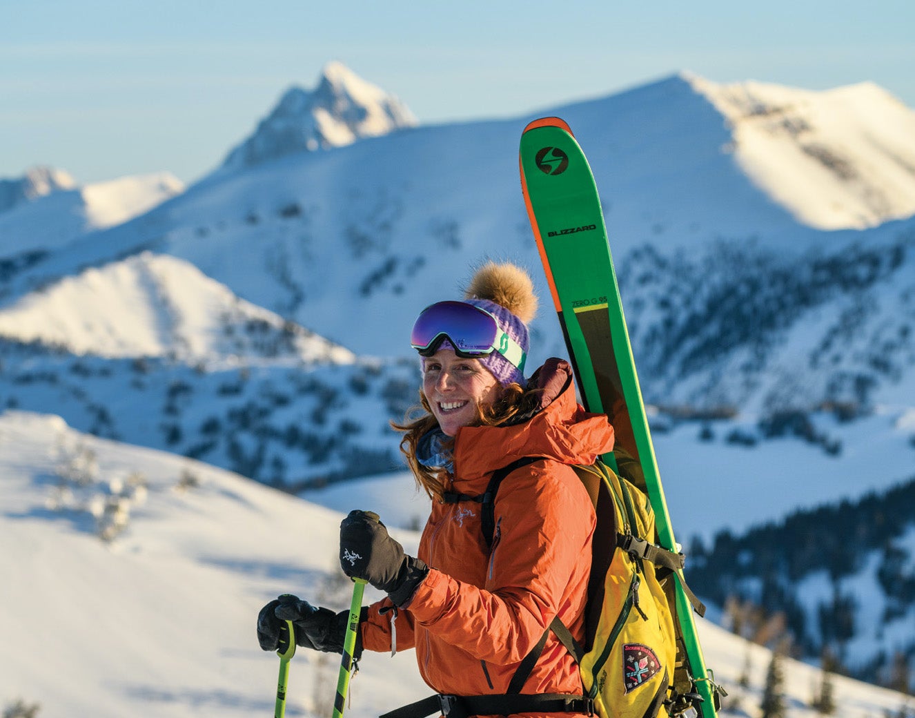 Crystal Wright poses for a picture while ski touring