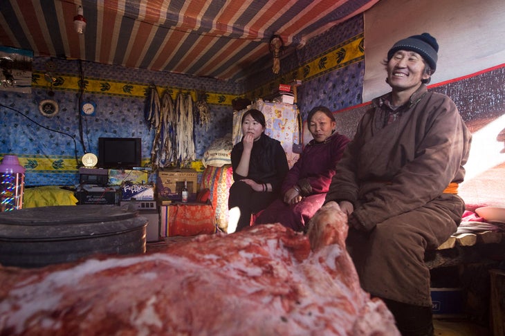 Skiing Mongolia Tea and thawing meat, dripping blood on the floor, in Ganbat’s hut.