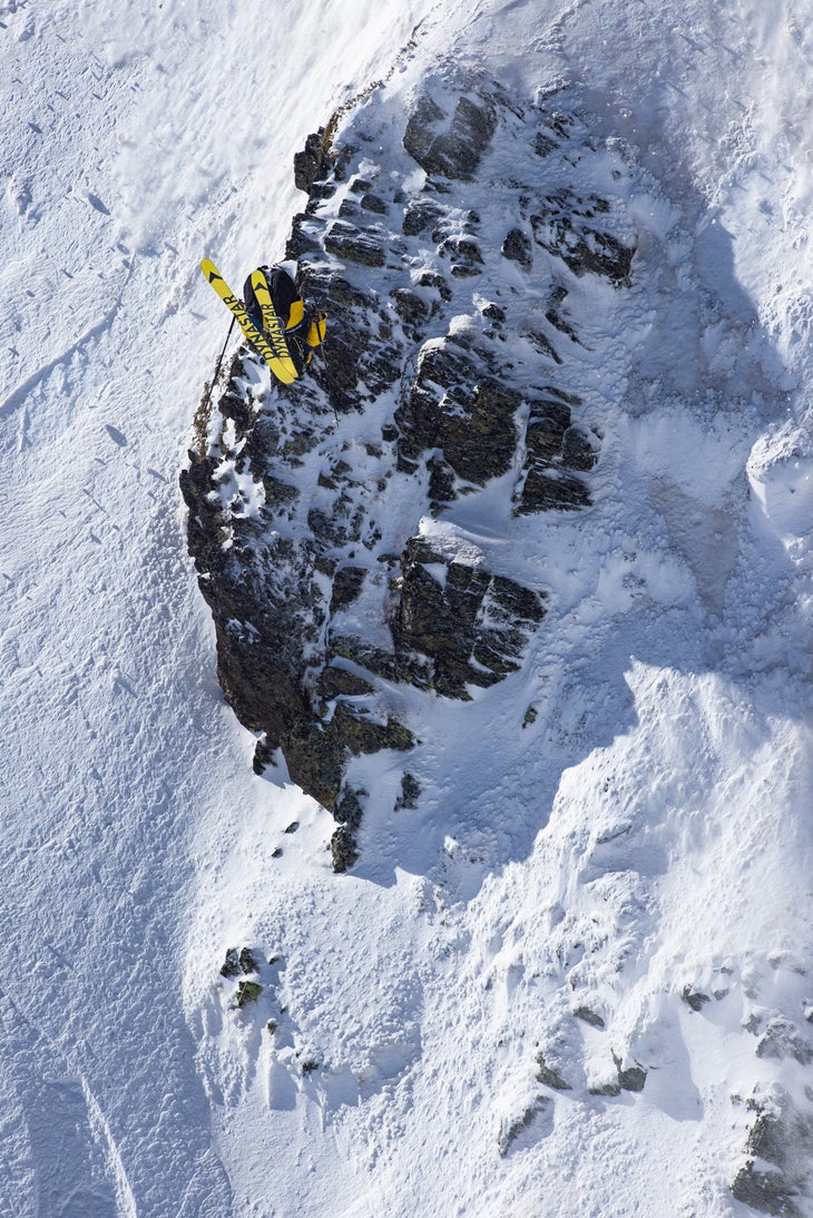 Skier backflipping off cliff on Freeride World Tour