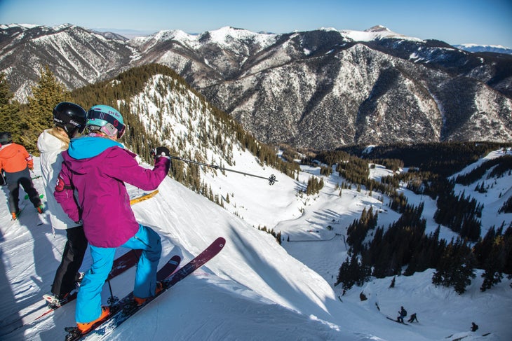 Skiers stand atop West Basin, Taos, NM