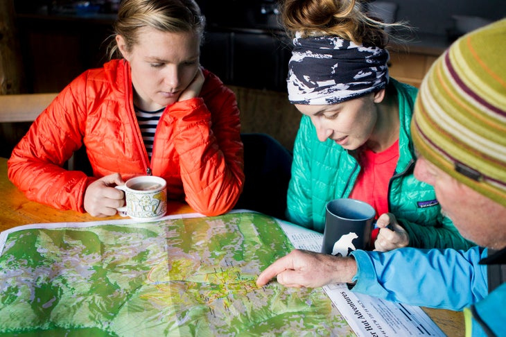 Women check out a backcountry topo map togetherr