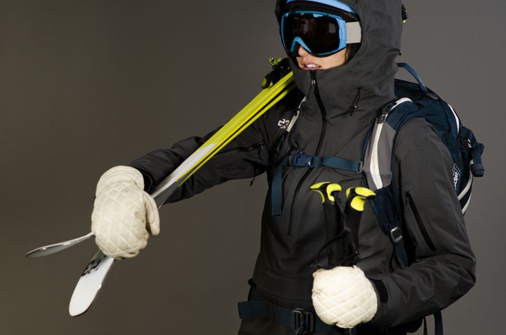 model holding skis in MADE jacket