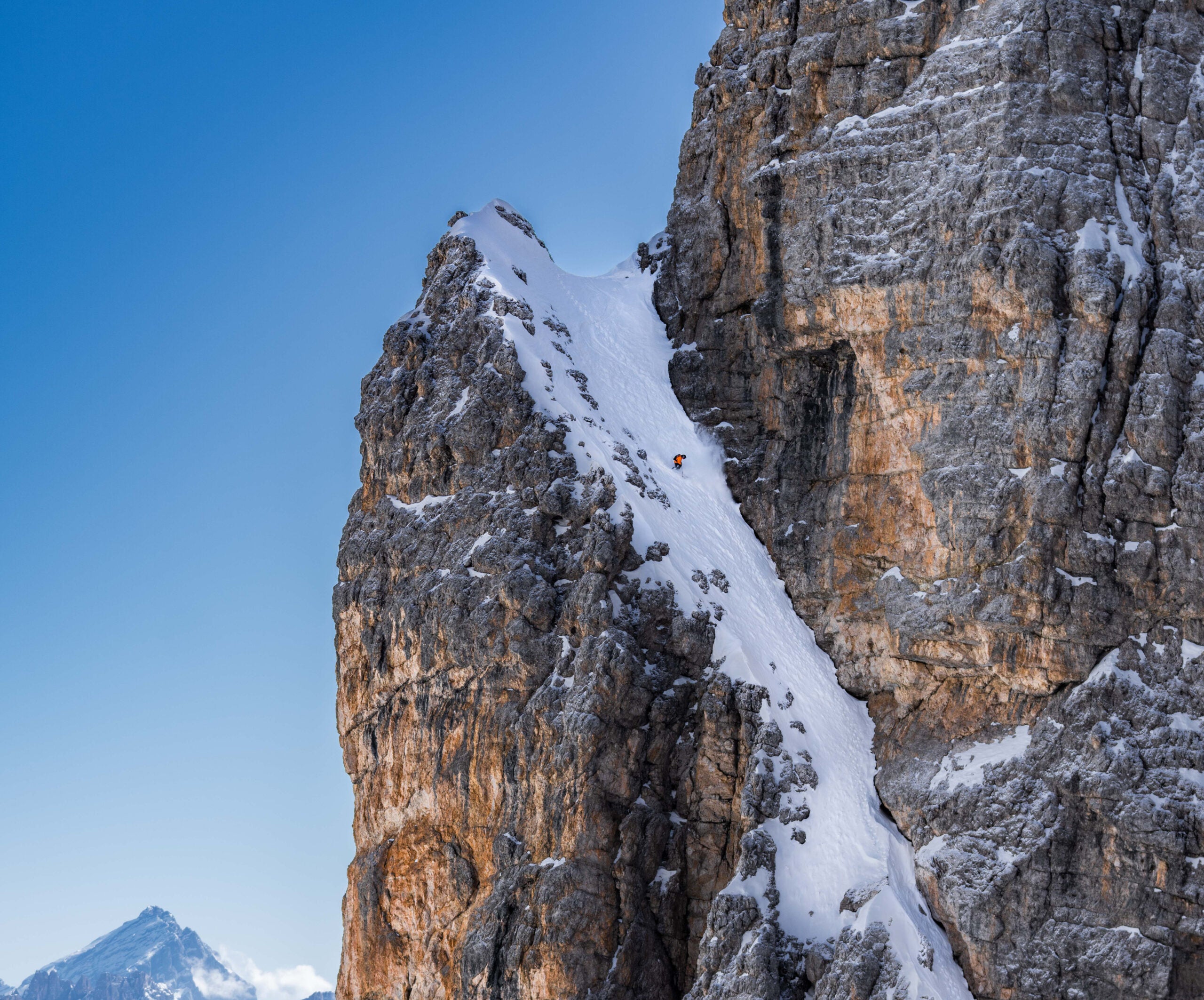 Skier on exposed couloir