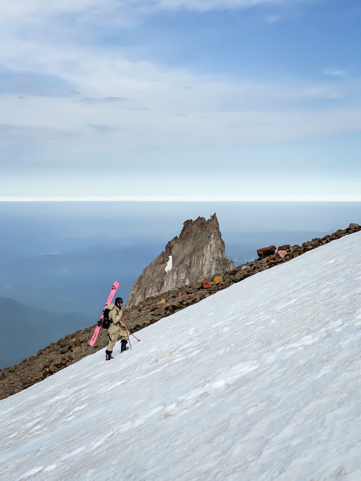 Skier climbing past Illumination Rock on Mt. Hood