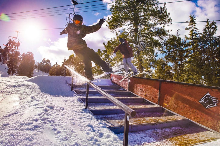 Snowboarder having fun and hitting the rails
