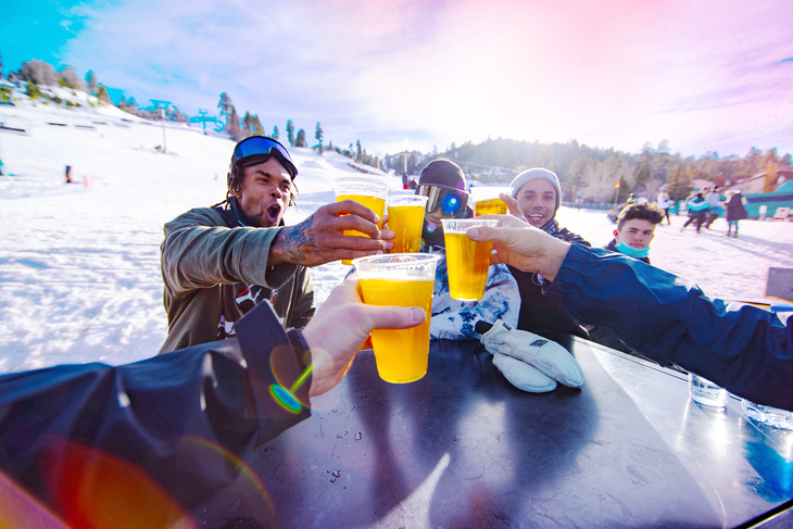 friends cheers beverages on a snowy day