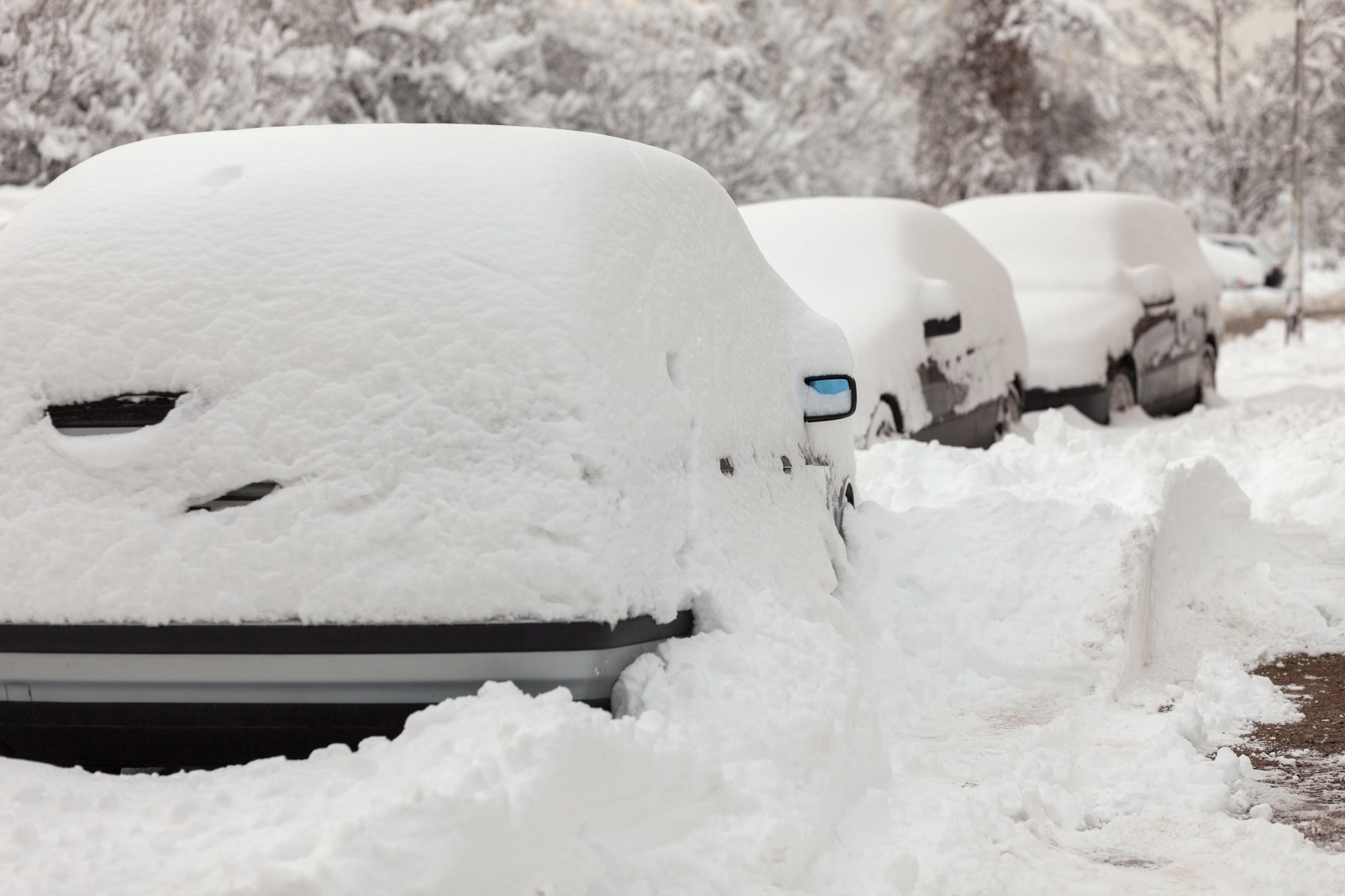 Cars buried under snow