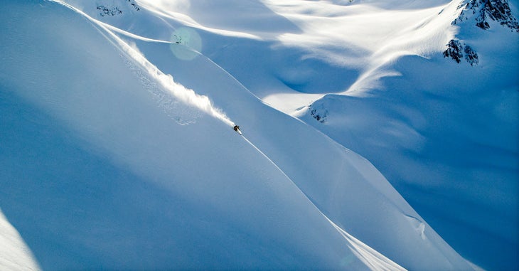 Skier shredding big mountain line