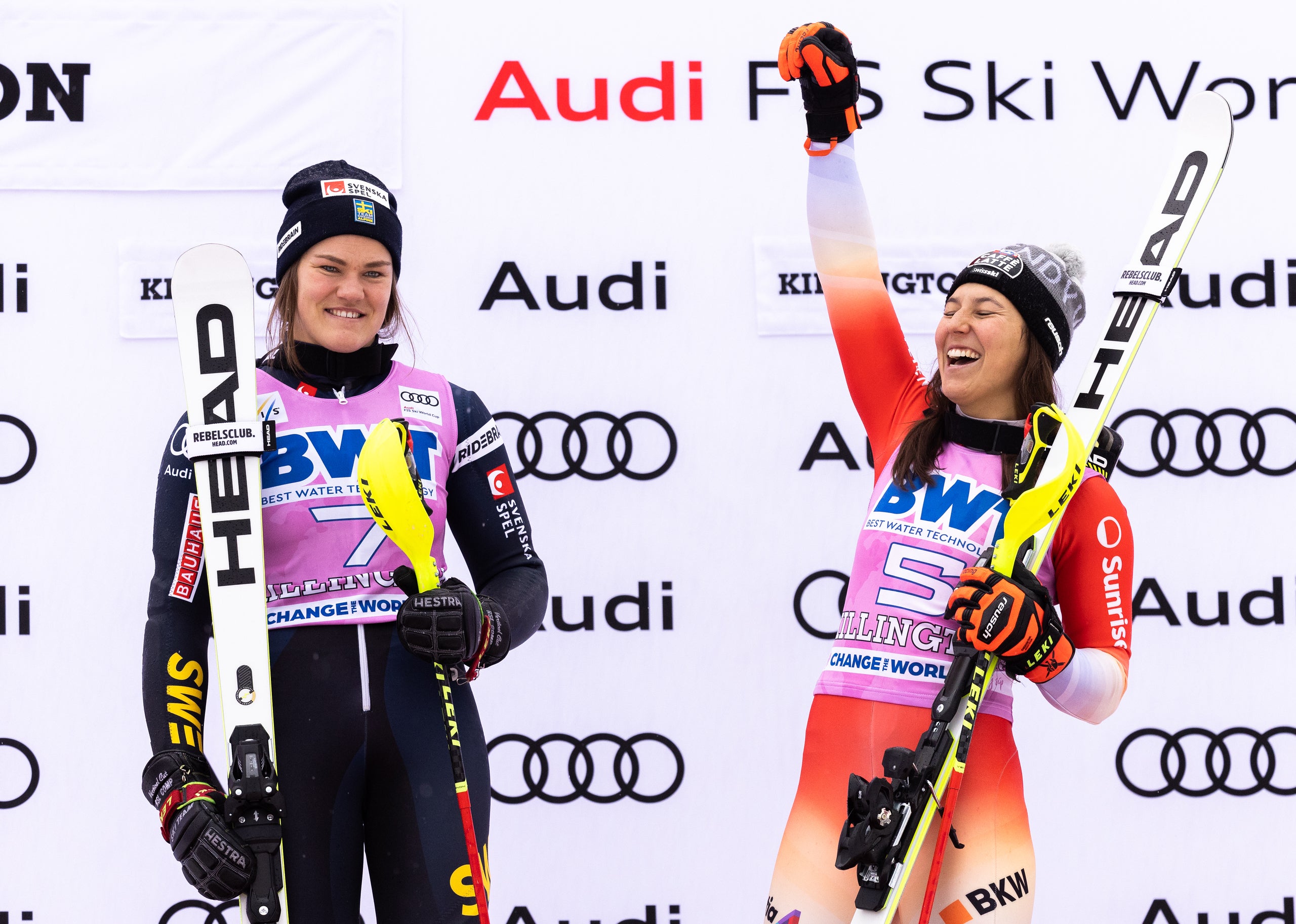 Wendy Holdener of Switzerland and Anna Swenn Larsson of Sweden celebrate a shared victory on the podium after the second run of the slalom at the HERoic Killington Cup Presented by Stifel on November 27, 2022 in Killington, Vermont.