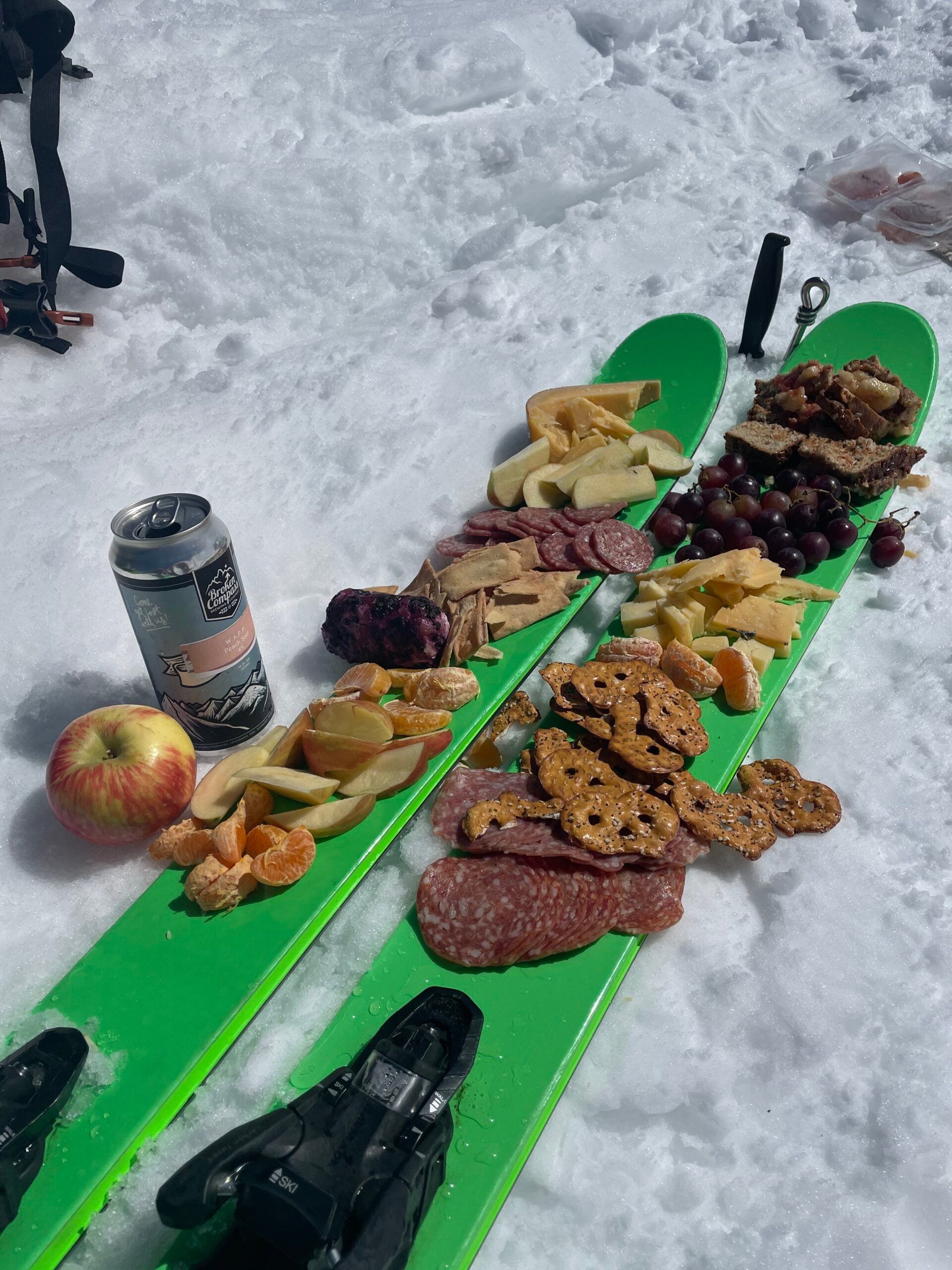 Different charcuterie snacks sit on top of two skis.