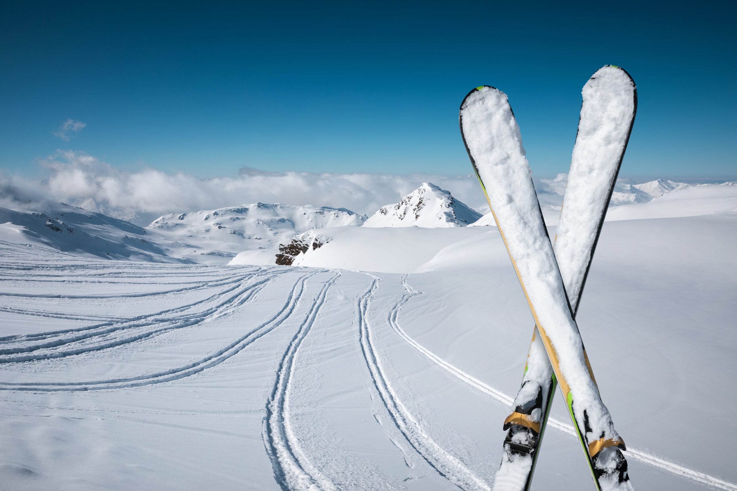 Panoramic view on snowcapped skis on the top of ski slope with view on the mountains. Val Thorens, France.