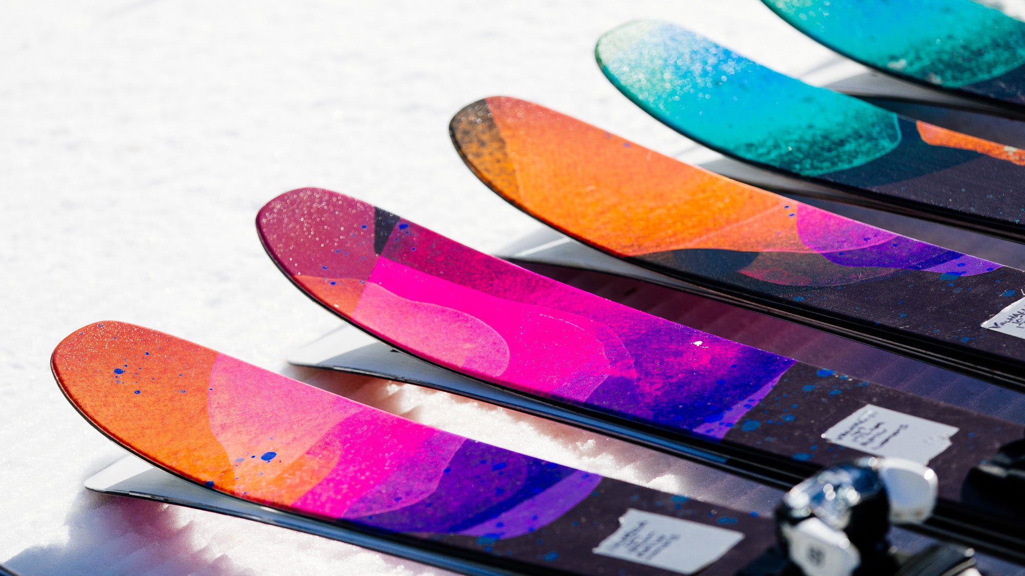 Closeup of colorful ski tips on snow
