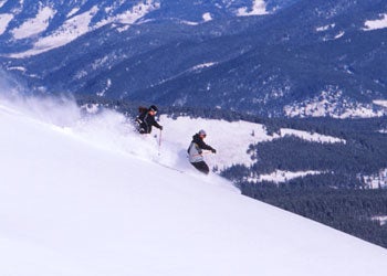Hike There, Ski Here Against the backdrop of a desolate (by our standards) mountainside, skiers eagerly start down their first run of the season.