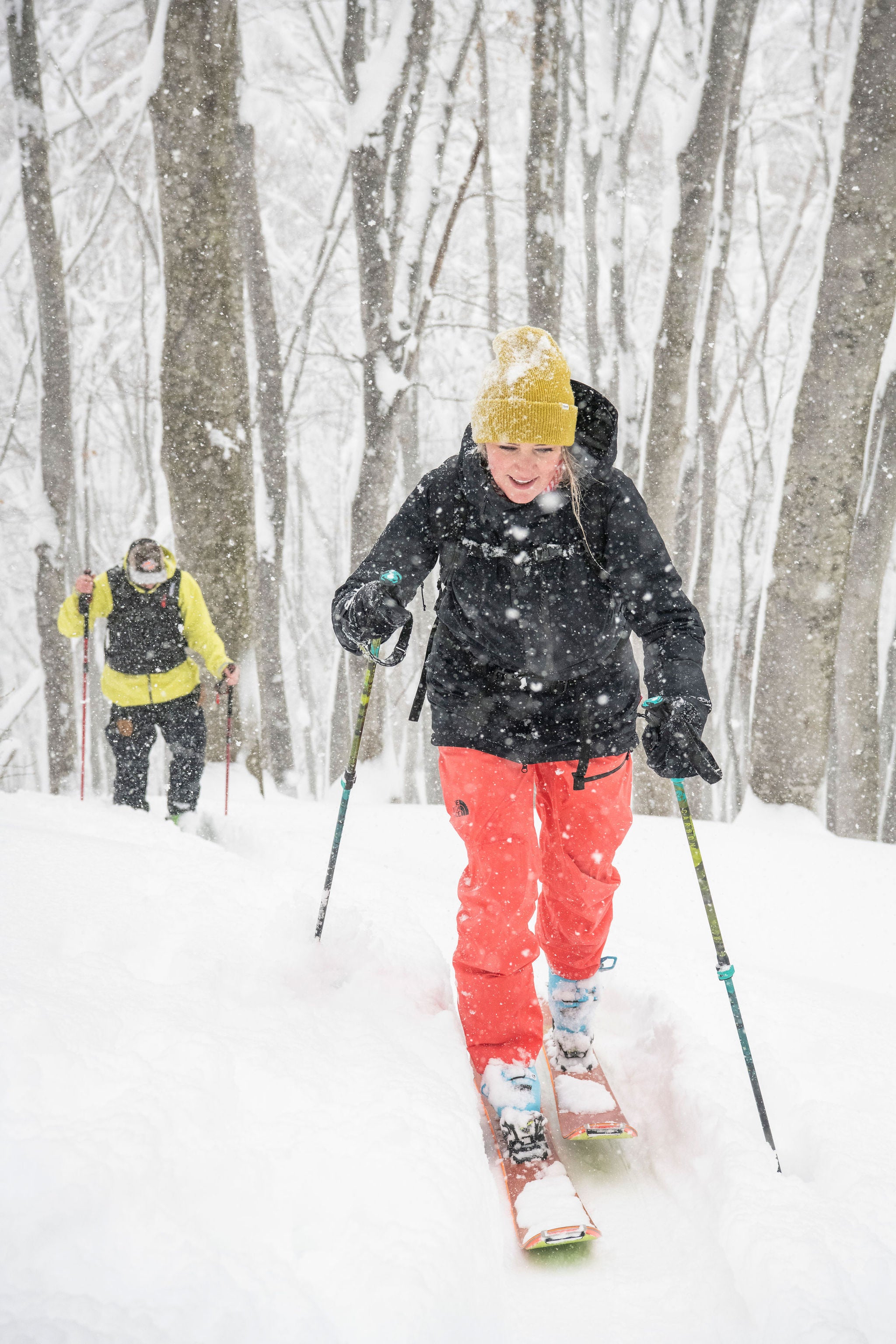 two skiers touring in a Japanese forest